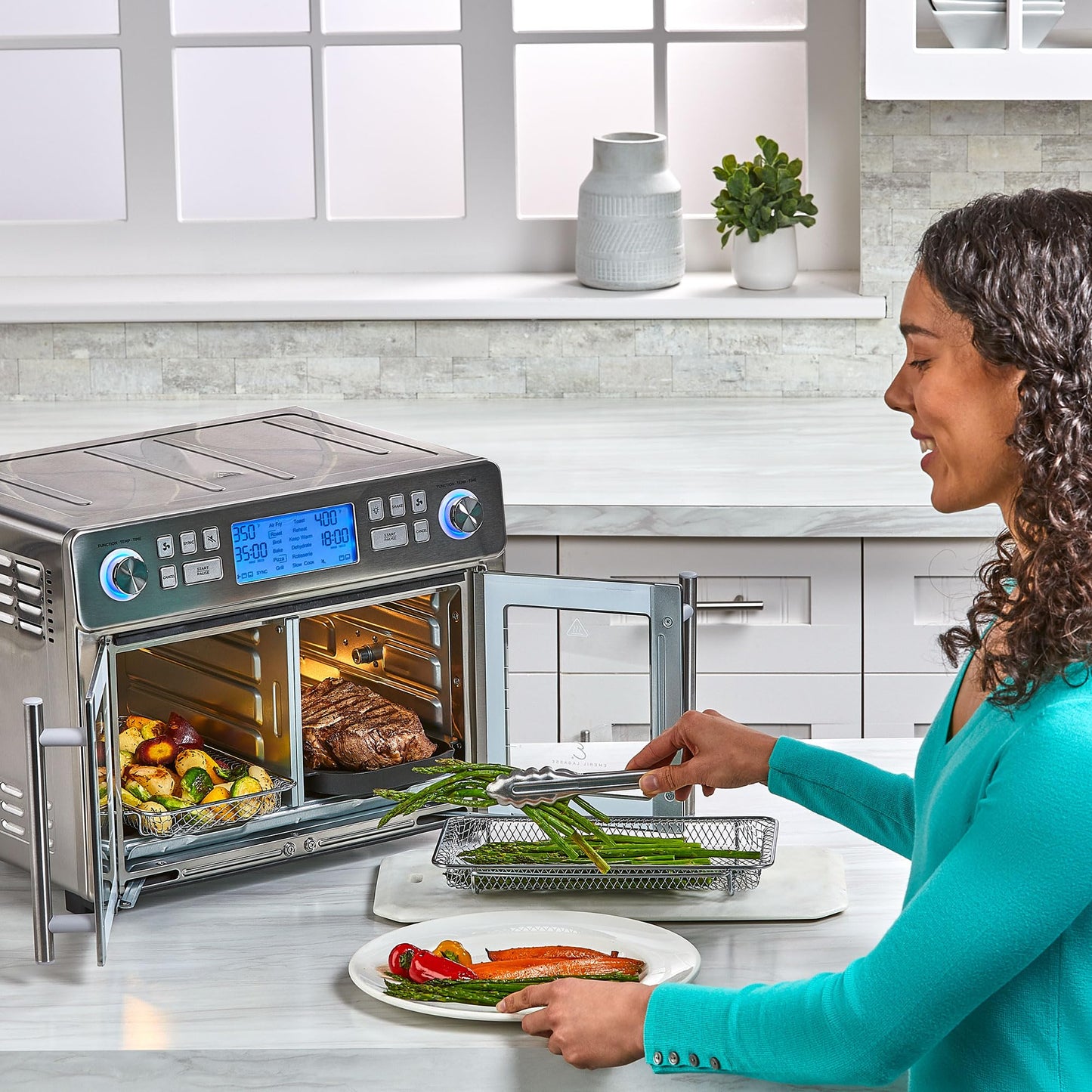 Emeril Lagasse Dual Zone Oven: 25QT air fryer oven, dual cooking zones, fast cooking, French doors, large capacity.